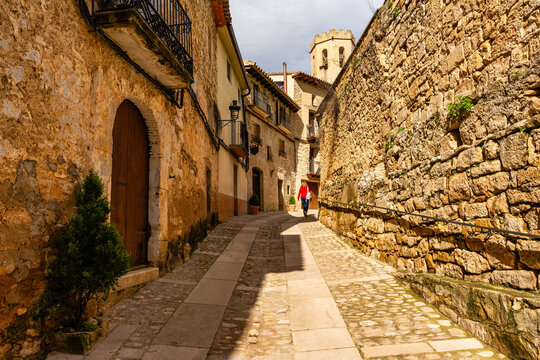 Tourist woman enjoying the charming medieval streets of the village of Valderrobres, Teruel, Aragon.