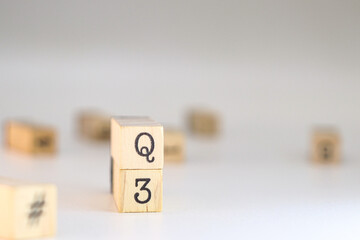 Third quarter acronym. word Q3 written on wooden cubes isolated on white background with copy space. Concept of finance or results analysis.