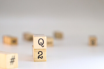 Second quarter acronym. word Q2 written on wooden cubes isolated on white background with copy space. Concept of Business Accounting, Automotive classification, Quarters