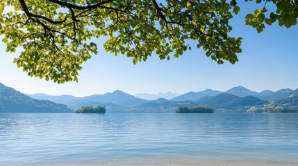 A serene lake surrounded by mountains and lush greenery, with a clear blue sky overhead.