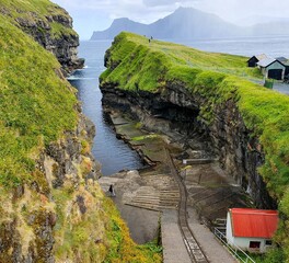 The Gjogv village on the Faroe Islands, named after a 200-metre (650 ft) long sea-filled gorge that runs to the sea from the village.