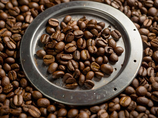 Fototapeta premium Roasted Coffee Beans: A close-up shot showcasing the rich texture and inviting aroma of freshly roasted coffee beans. The focus is on the detail of the beans within the metallic container.