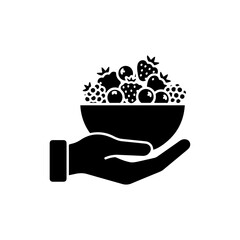 Hand holding bowl of mixed berries rich in antioxidants