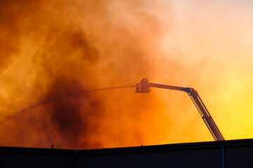 Large fire engulfs industrial building in Mölndal Sweden with firefighters battling intense flames