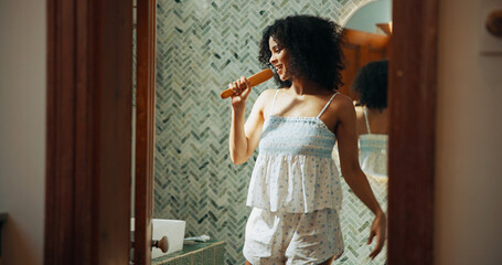 Woman, brush and singing with smile in bathroom for playful, concert and voice for sound and...