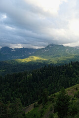 summer landscape with green mountains against cloudy sky, nature background. freedom, adventure, unity with wild nature, tourism, travel concept. scenic nature view. Arkhyz, Caucasus mountains