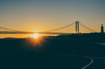 people watching sunrise at maat museum of art, lisbon, portugal, bridge in the background