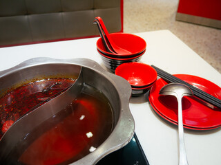 Sichuan mala hotpot (mala huoguo) set on restaurant table.