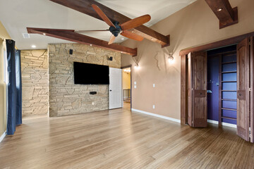 Spacious living room with wooden flooring and sliding doors leading to a bright outdoor area