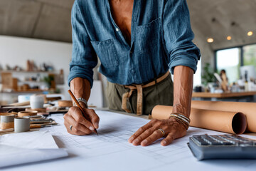 Designer sketches detailed plans in a modern studio during a creative afternoon