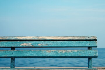 Wooden bench by ocean