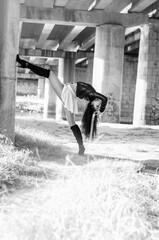 Close-up portrait of a fantastic young model girl posing in the park on a sunny day. Black and white photo.