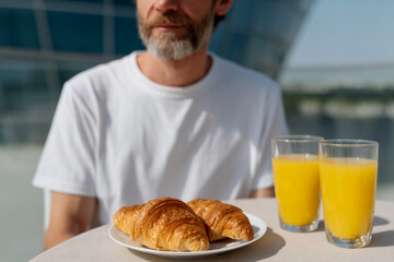 Outdoor breakfast with croissants and orange juice
