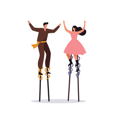 Fototapeta premium Two people joyfully dancing on stilts in a playful outdoor setting