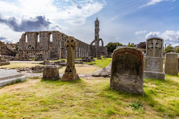 The ruins of St Andrews Cathedral overlook the sea, surrounded by ancient tombs and old stone...