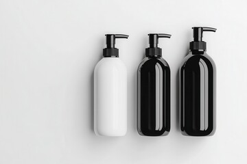 Three cosmetic bottles, white and black, in a minimalist arrangement