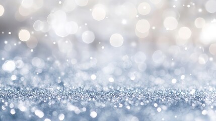 A blurred background of silver glitter and bokeh lights creating a festive atmosphere for celebrations