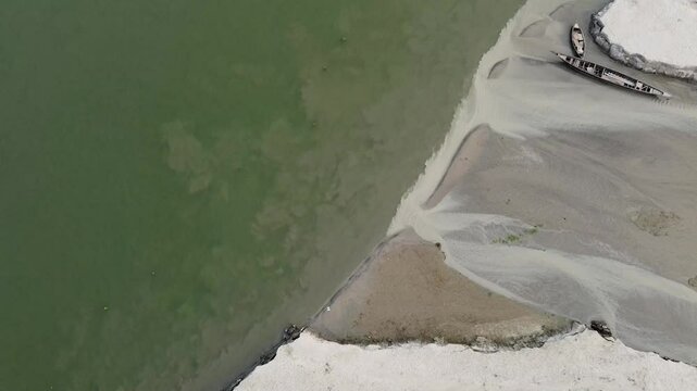 Drone shot of river bank and boat in Jamuna River Bangladesh