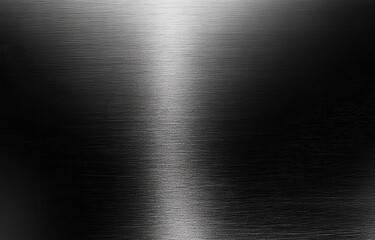 Brushed metal surface texture.  A sleek, dark gray metal panel with subtle light reflections creating a brushed effect.  The surface appears smooth and polished, showcasing a high-quality finish
