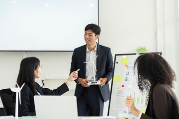 Engaging Discussion on ESG Practices. A diverse team animatedly discussing sustainable initiatives in a corporate environment.