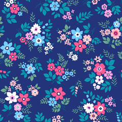 Beautiful floral pattern in small vintage flowers. Small blue, red and white flowers. Bright blue background. Ditsy print. Floral seamless background. Gentle template for fashion prints. Stock 
