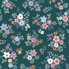 Vector seamless pattern. Cute pattern in small flowers. Small pale colorful flowers. Green Blue background. Ditsy floral background. Trendy template for fashion prints. Stock vector.