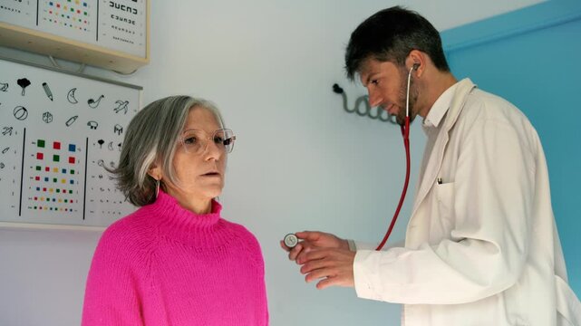 Doctor examining patient's chest with stethoscope in medical office