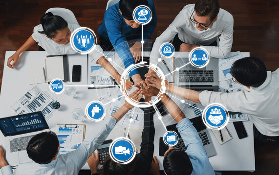 A diverse group of professionals engages in a collaborative business strategy session, leveraging technology and teamwork to drive innovation and successful outcomes. Amity