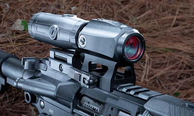 Closeup of a magnifier and red dot sight on an assault rifle