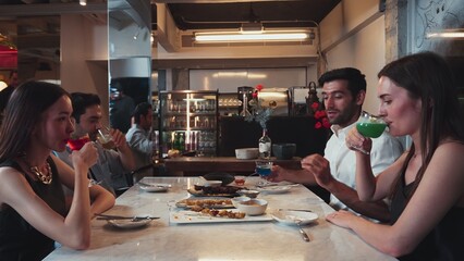 Making cheers with cocktail drinks of group friend surrounded grill and fried meat special menu featuring unique chef table menu on table dinner at luxurious restaurant celebrating together. Vinosity.