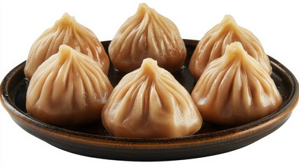 Close view of steamed dumplings served on white background