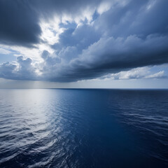Fototapeta premium Dark blue sea surface under a cloudy sky.