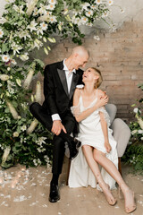 Attractive young couple in love in wedding dresses spending time together