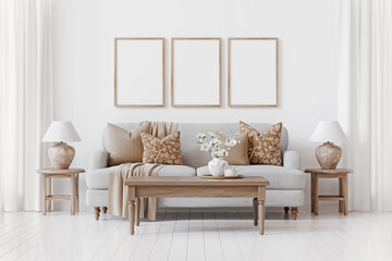 Nice traditional interior with three empty vertical frames on the wall above cozy sofa. Decorated...
