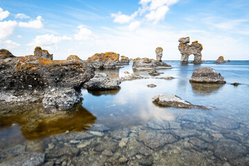 Limestone rocks formation raukar long exposure water reflection blurred clouds stones Baltic Sea Gotland Fårö island Sweden 