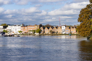 Attractive waterside properties of Strand on the Green in Chiswick viewed from Kew Green on banks of River Thames