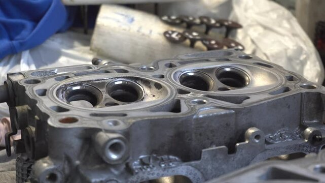 Car service. The cylinder valve and Cylinder head. Damaged cylinder head, worn valves, damaged engine