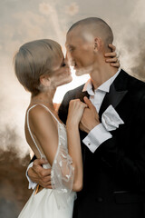 Attractive young couple in love kissing and hugging in romantic foggy atmosphere