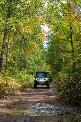 ATV, riding on trail through wooded scenery, north woods all terrain vehicle, UTV