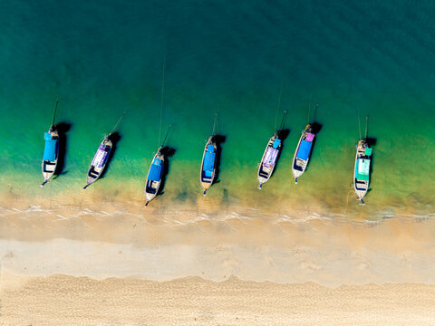 white sand beaches in asia with long tail boats. 