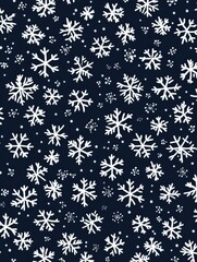 Festive winter holiday background with scattered snowflakes on dark blue surface creating a seamless seasonal pattern for christmas and new year celebrations