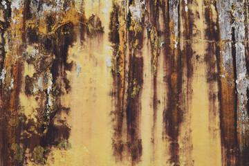 Cracked multicolor cement walls with stains from the weather.