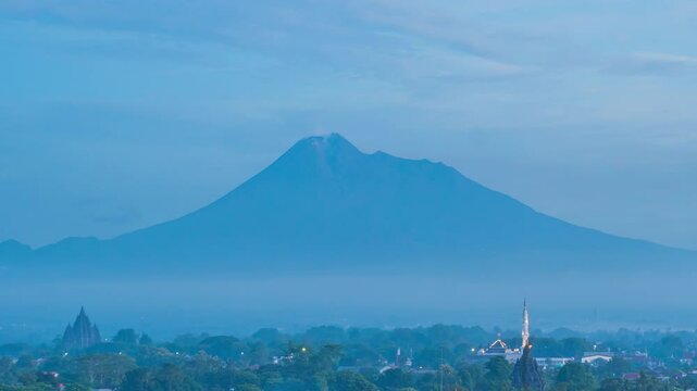  February 5, 2025. 4k timelapse, morning atmosphere in Prambanan area with Sojiwan temple and Mount Merapi in the background.