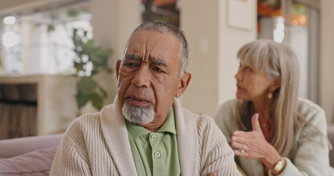 Frustrated, angry and senior couple or argument from disappointment, fight and disagreement with wife. Elderly woman, mature man and interracial partners in living room, house and retirement home