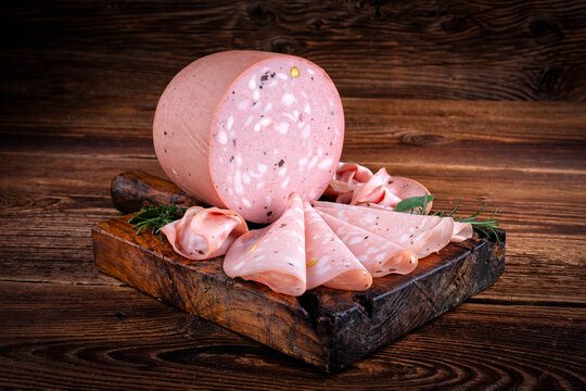 Traditional Italian artisan handcrafted fine mortadella with pistachio and truffle offered as close-up on design black board