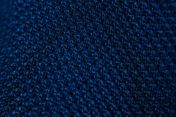 A close-up of a black mesh fabric with a circular knit pattern, highlighting the texture, weave structure and breathability. Ideal for textile and design references.