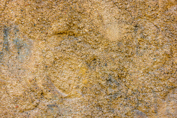 rugged beige concrete wall texture with pebbles