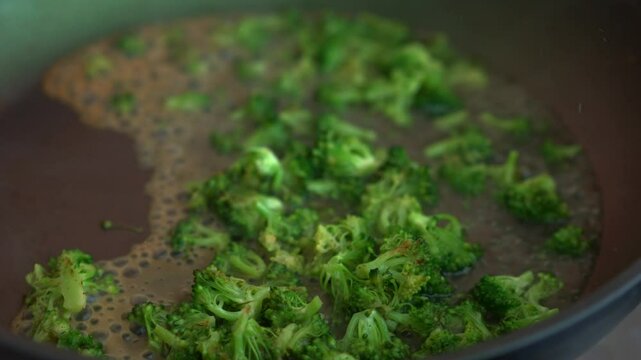 Fried broccoli on a frying pan.
Water evaporates from a hot frying pan.
Boiling water and green broccoli.
Fried broccoli.
Healthy cooking