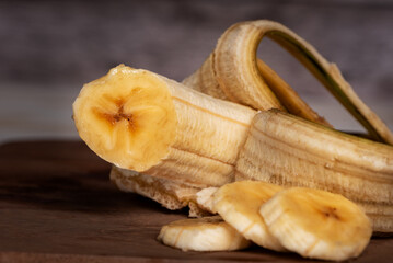 Close-up shot of a peeled banana, sliced into rounds, revealing the juicy interior of the fruit, extreme close-up.