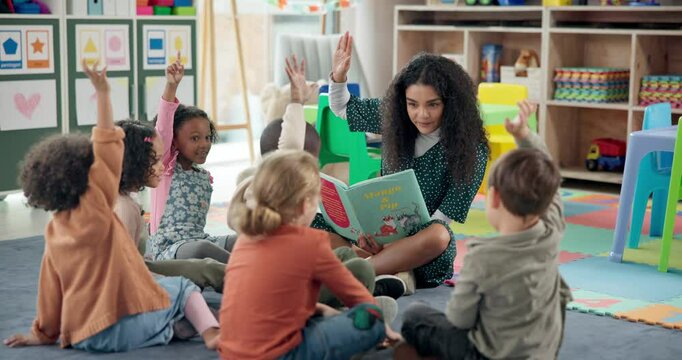 Woman, teacher and story book with hands raised in nursery for question, engagement or interaction. Female person, educator or instructor with elementary kids, answer or novel for listening activity